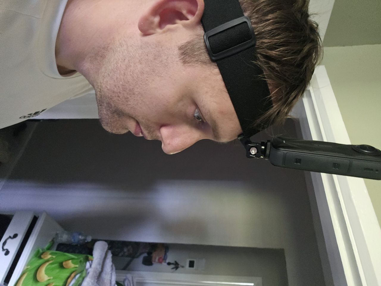 Side profile of the Insta360 X5 angled forward at eye level on a head strap
