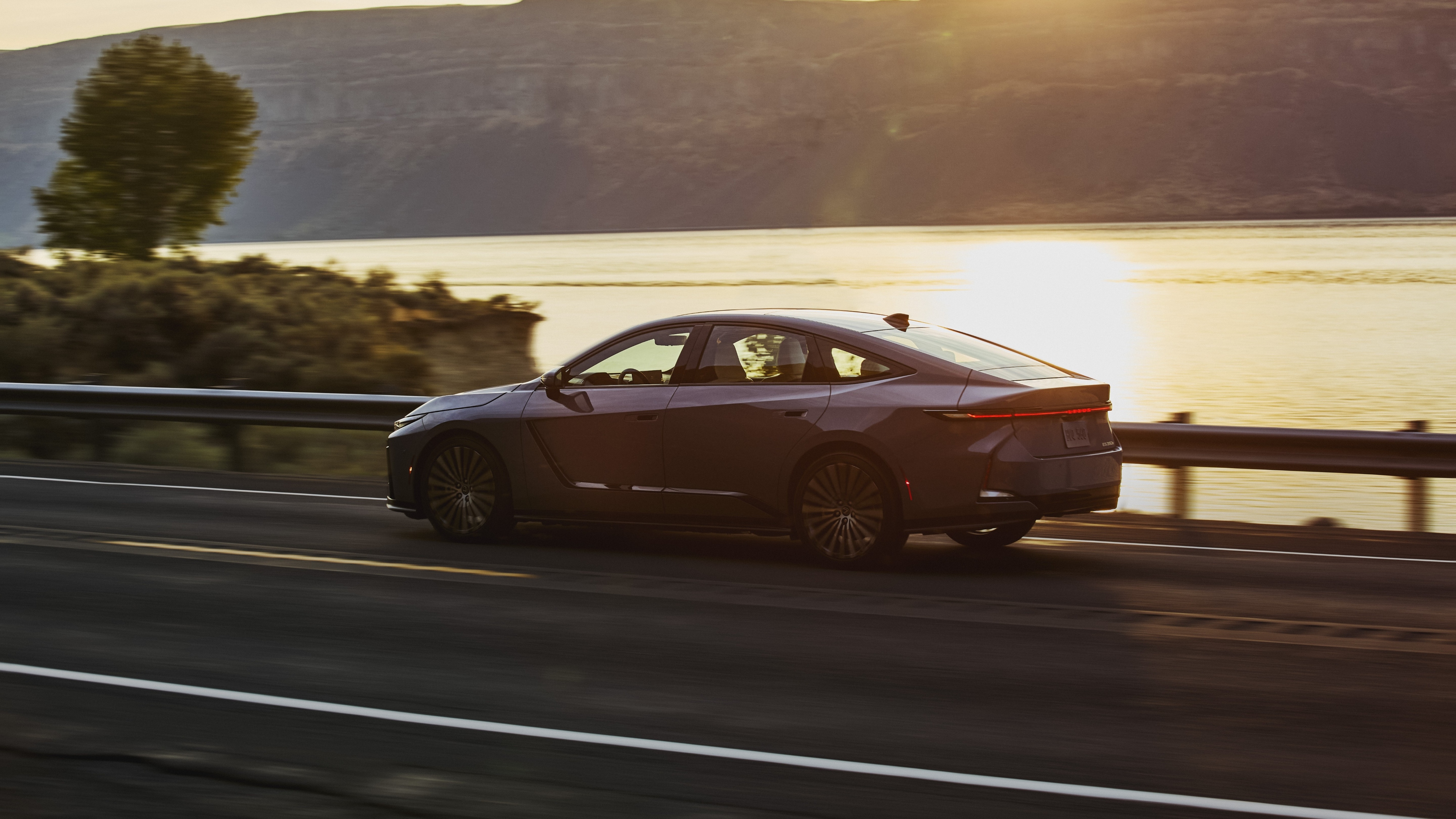 2026 Lexus ES 350e on highway at sunset