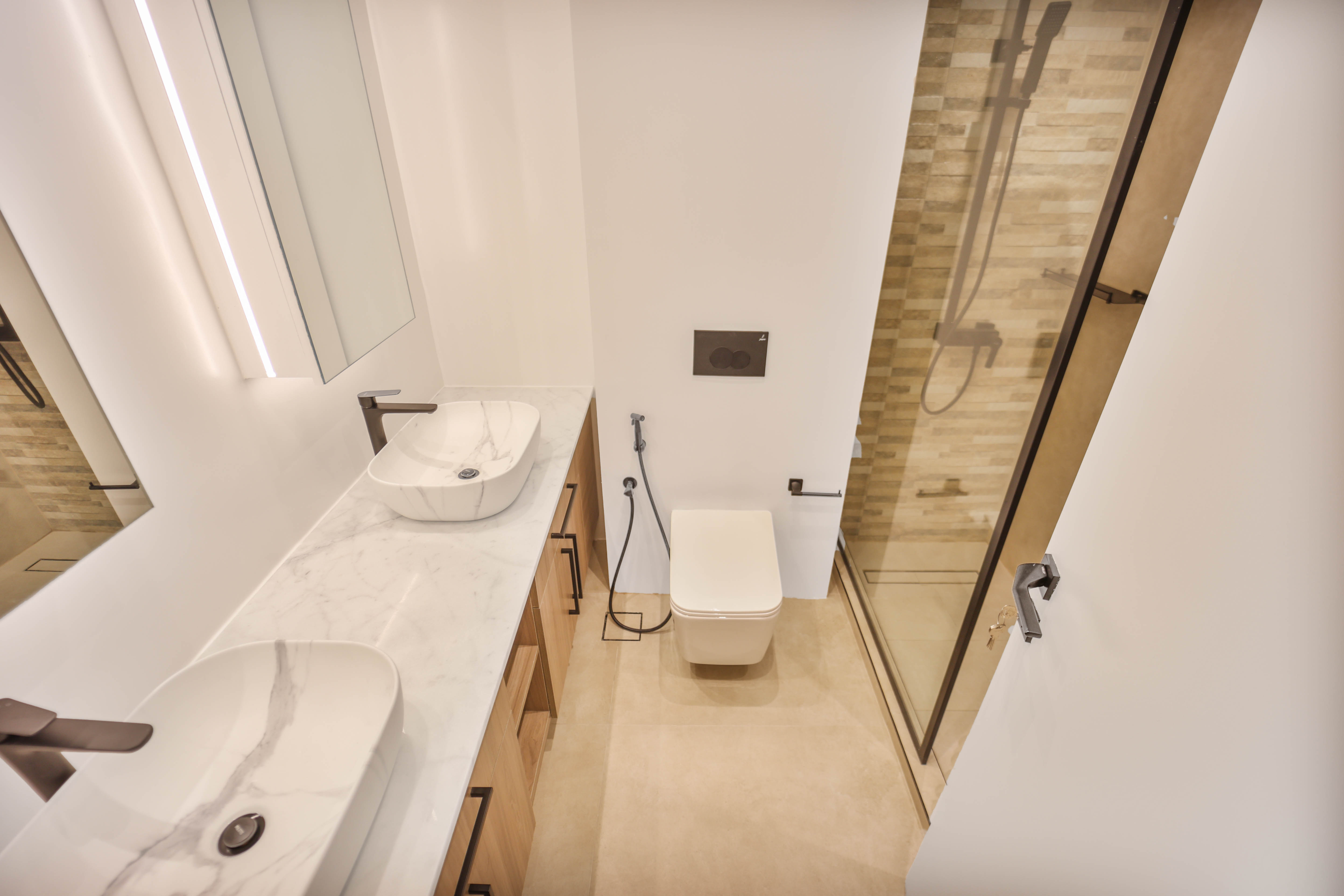 Modern bathroom with dual vessel sinks and wood vanity