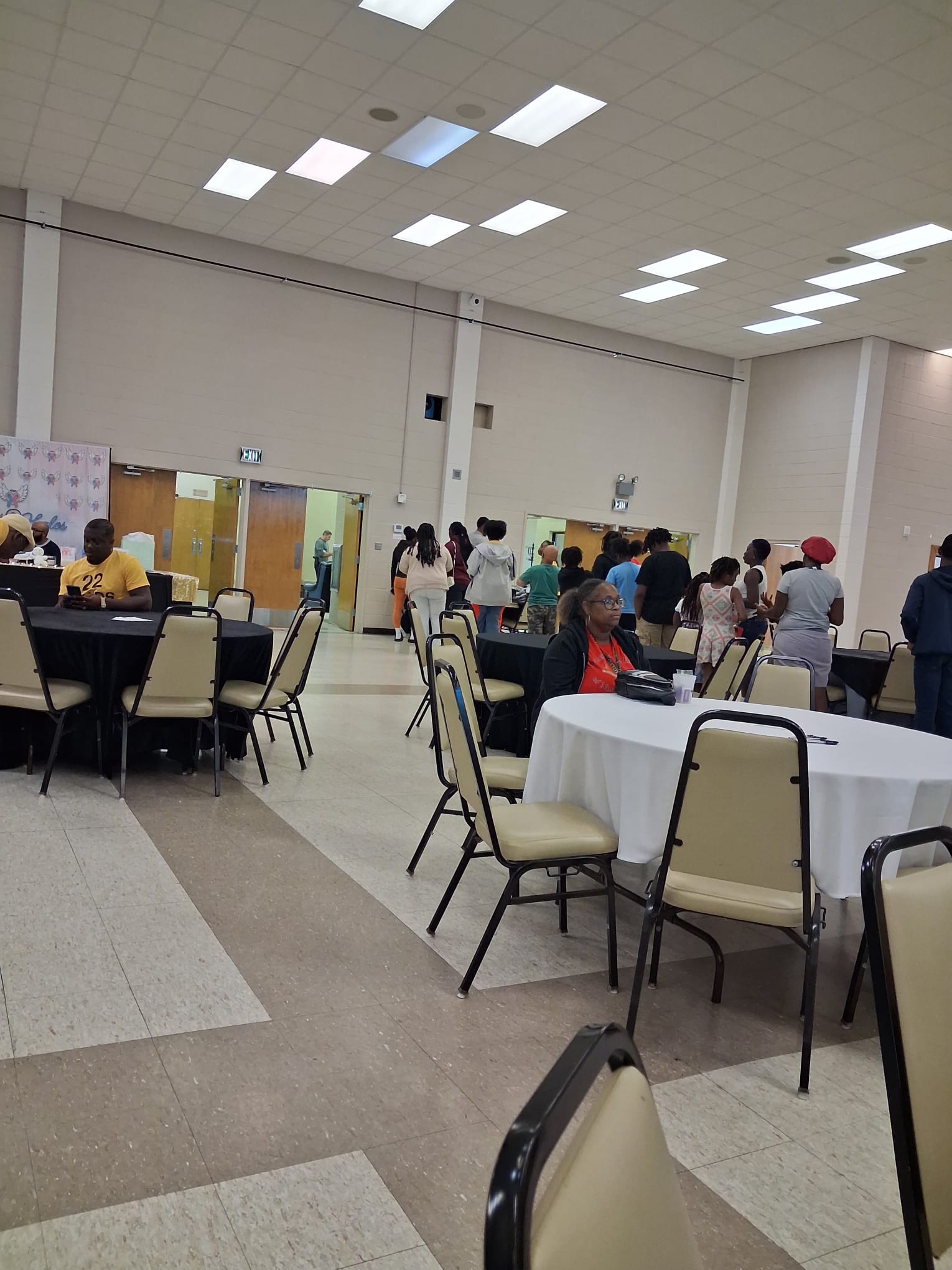 Families and community members gathered at round tables inside the civic center