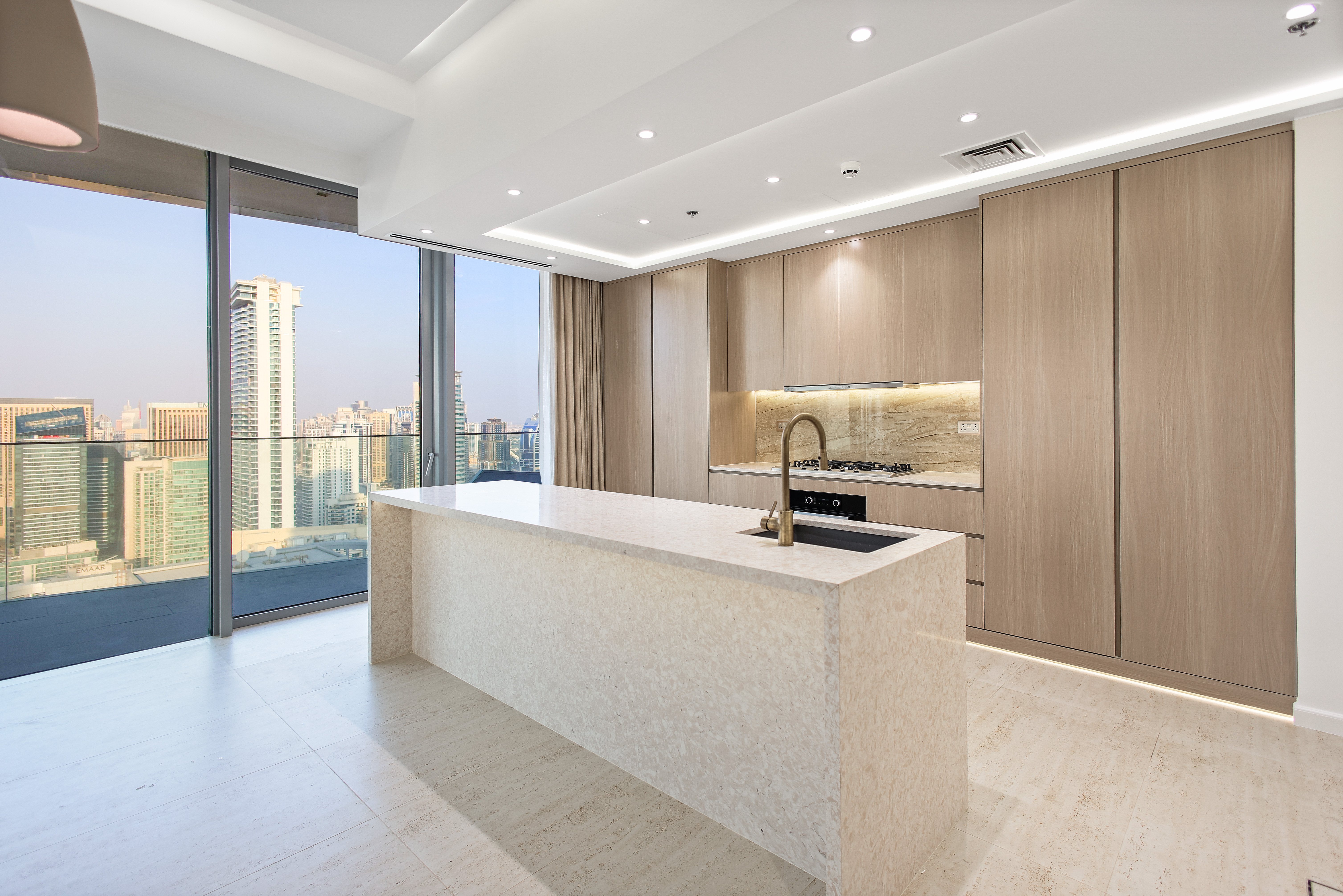 Modern kitchen with wood cabinets and city view