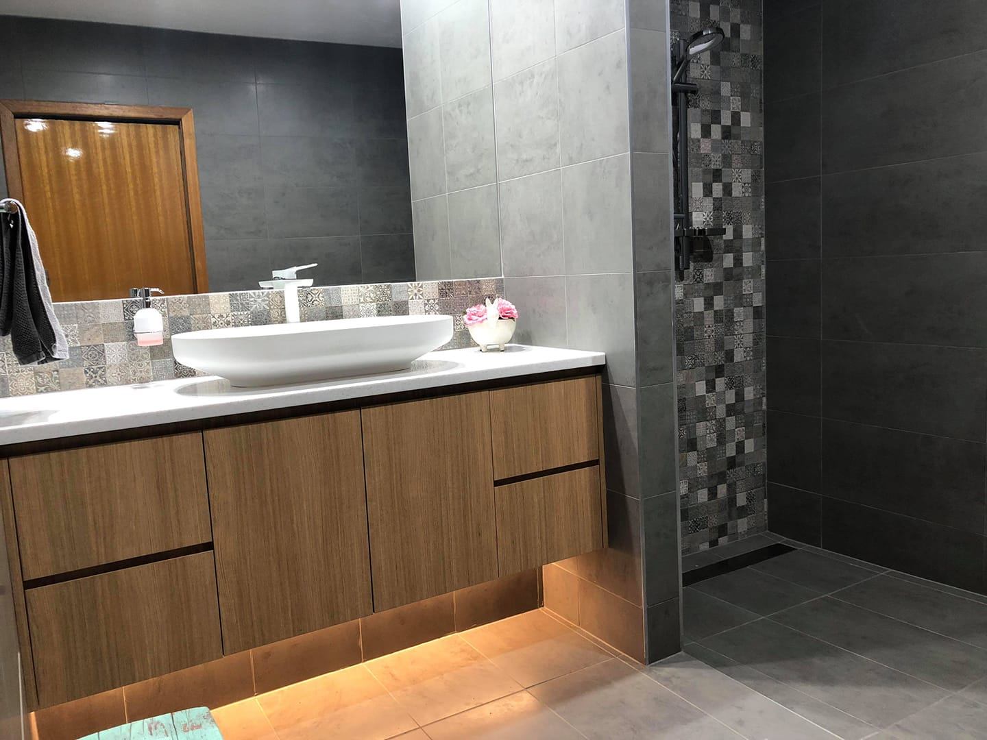 Residential bathroom with floating timber vanity, LED strip lighting and walk-in shower