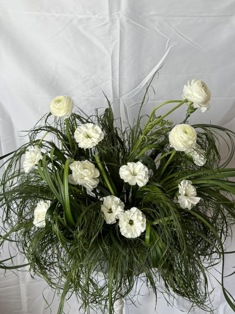 White ranunculus and carnations with flowing ornamental grasses modern arrangement