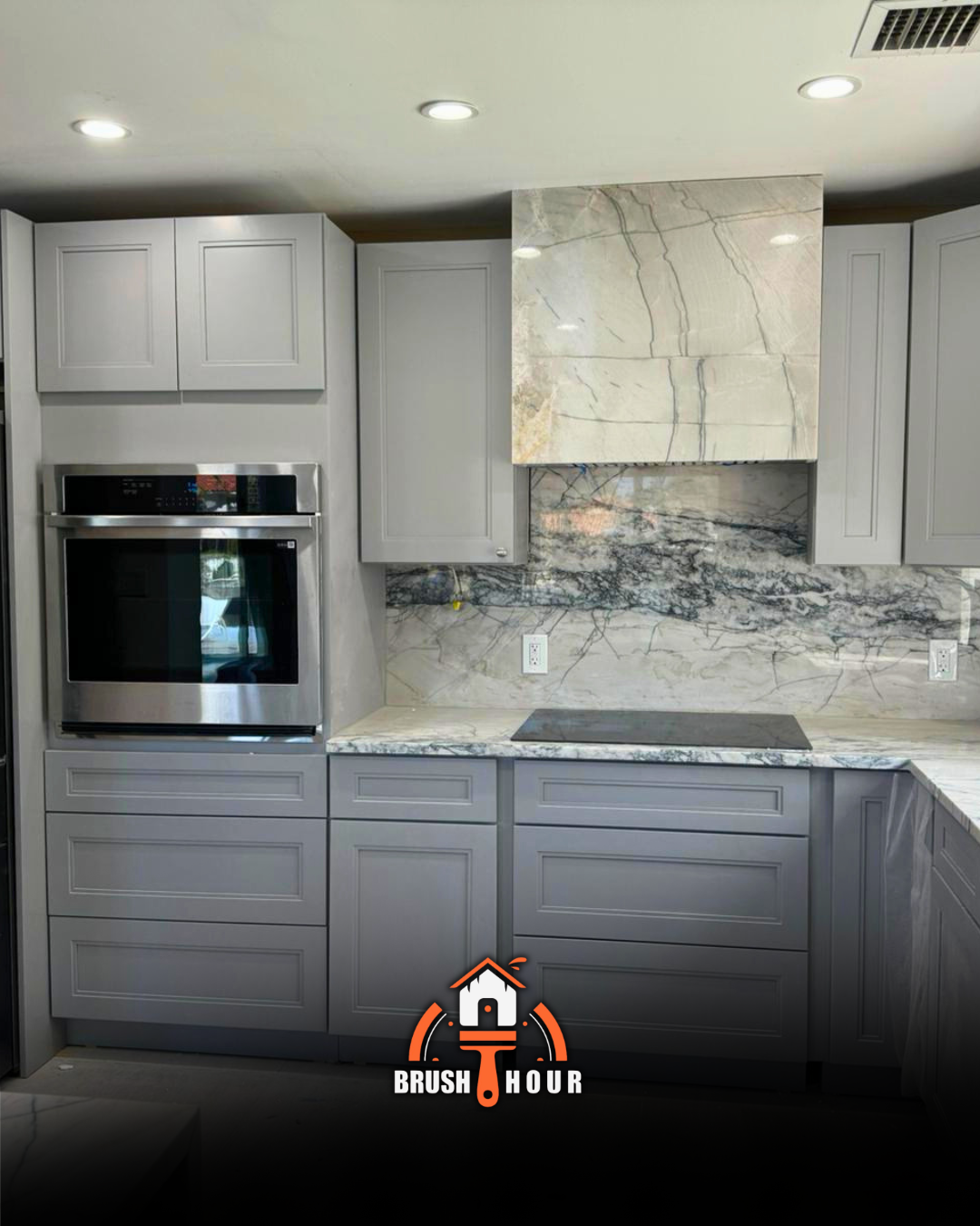 Kitchen with gray cabinets and marble
