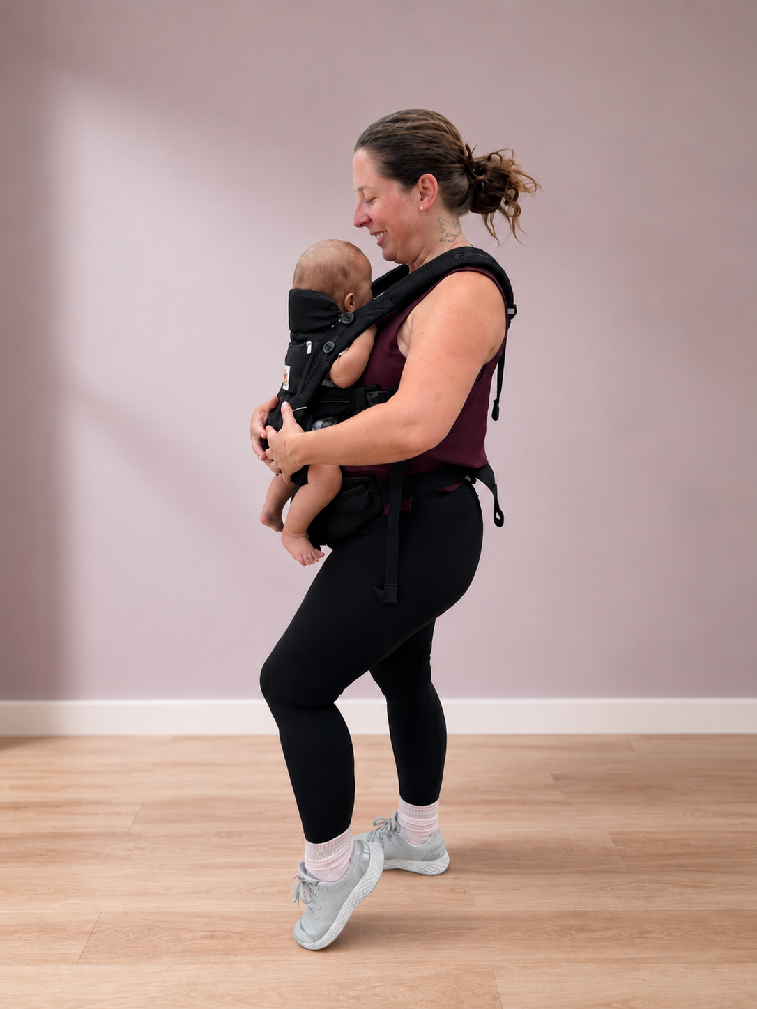 The instructor walking with her baby in a carrier, sharing a tender moment