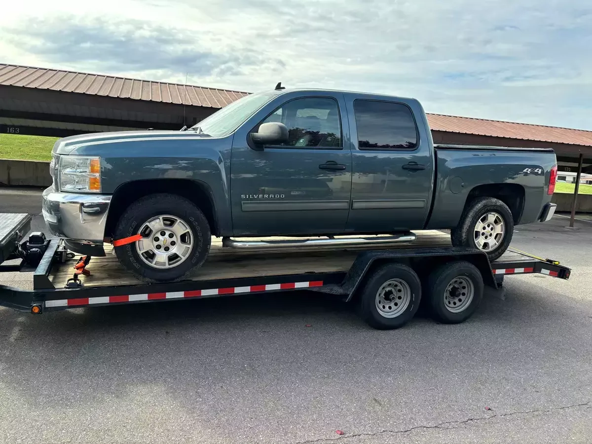 Chevrolet Silverado loaded on car hauler trailer