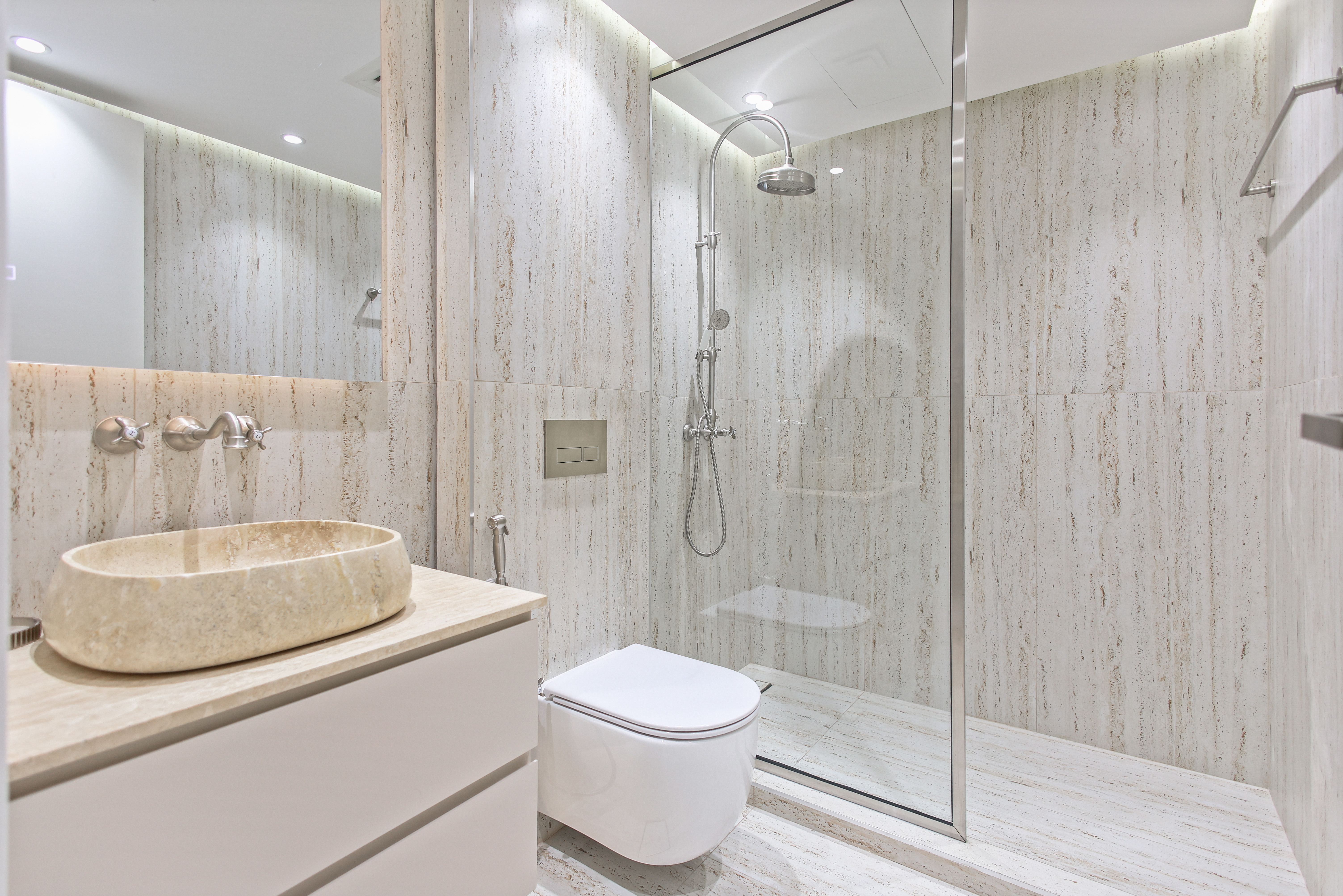 Modern bathroom with gray stone tile walls