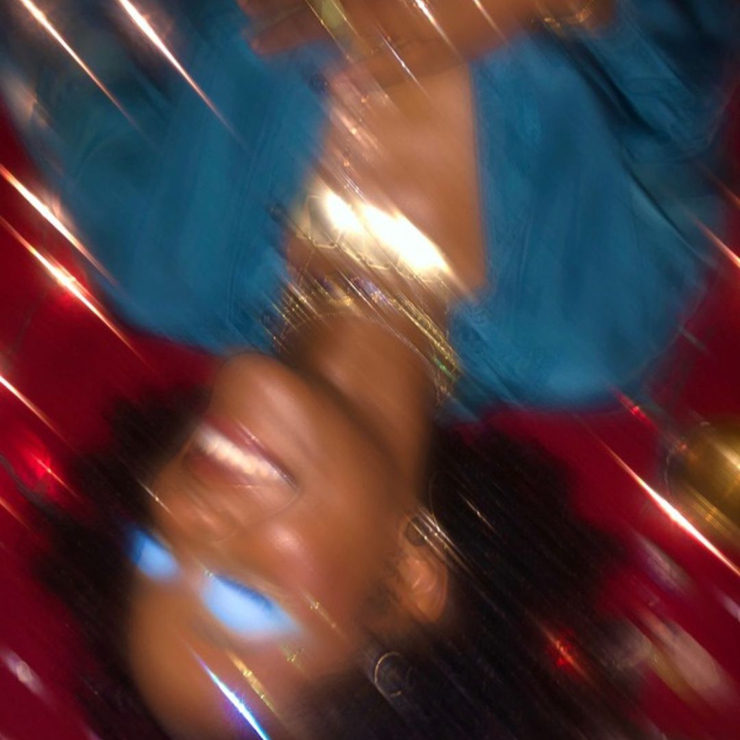 Blurry motion portrait with diagonal light streaks in red and teal
