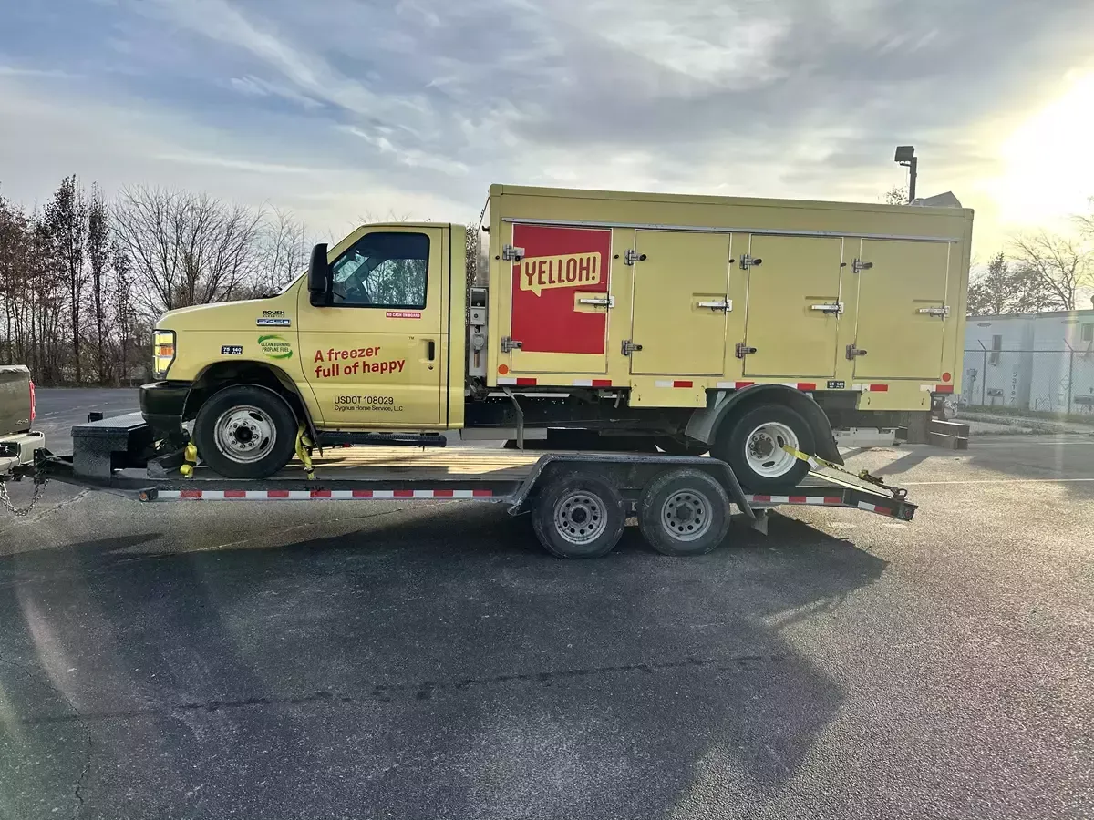 Large truck loaded on car hauler trailer