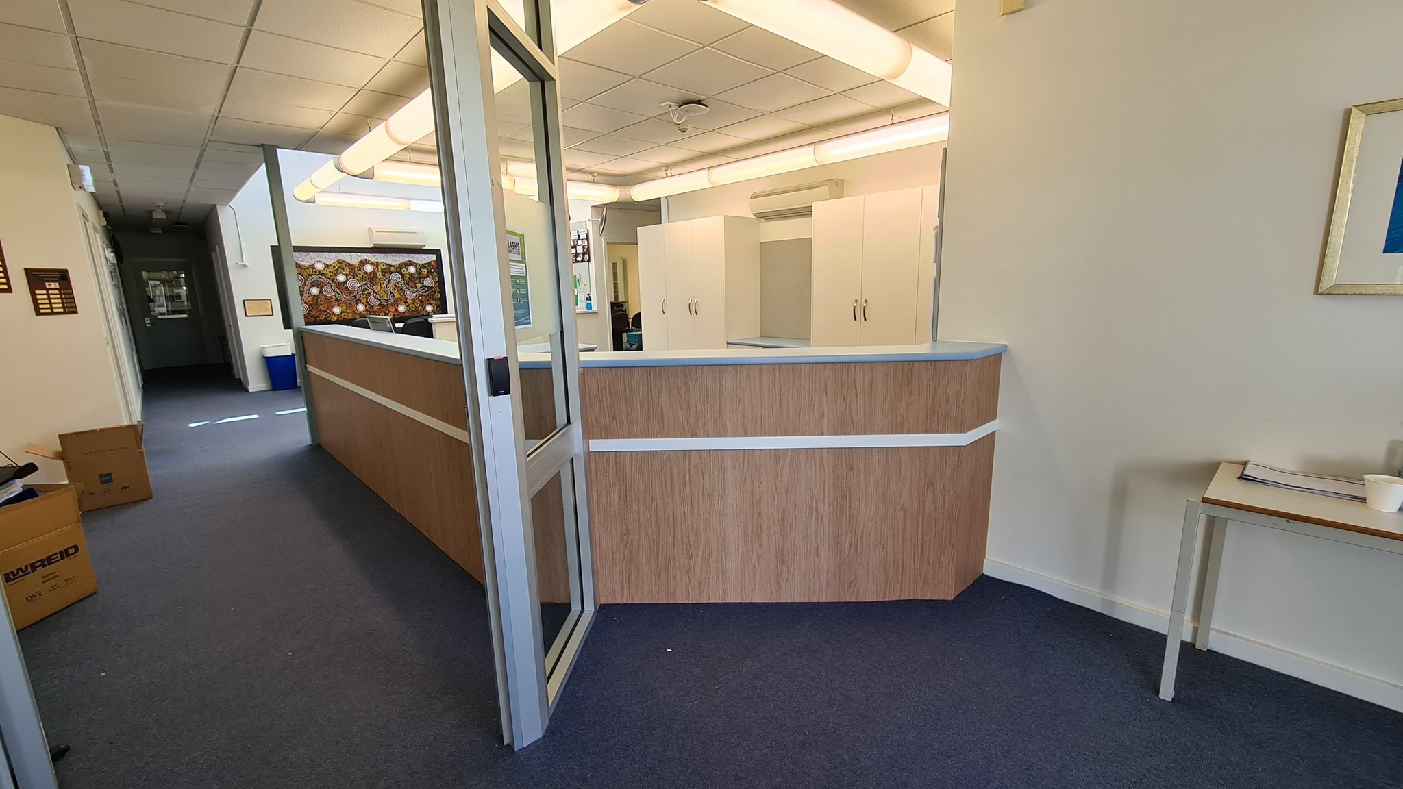 Modern white kitchen with handleless cabinetry, island bench and pendant lights