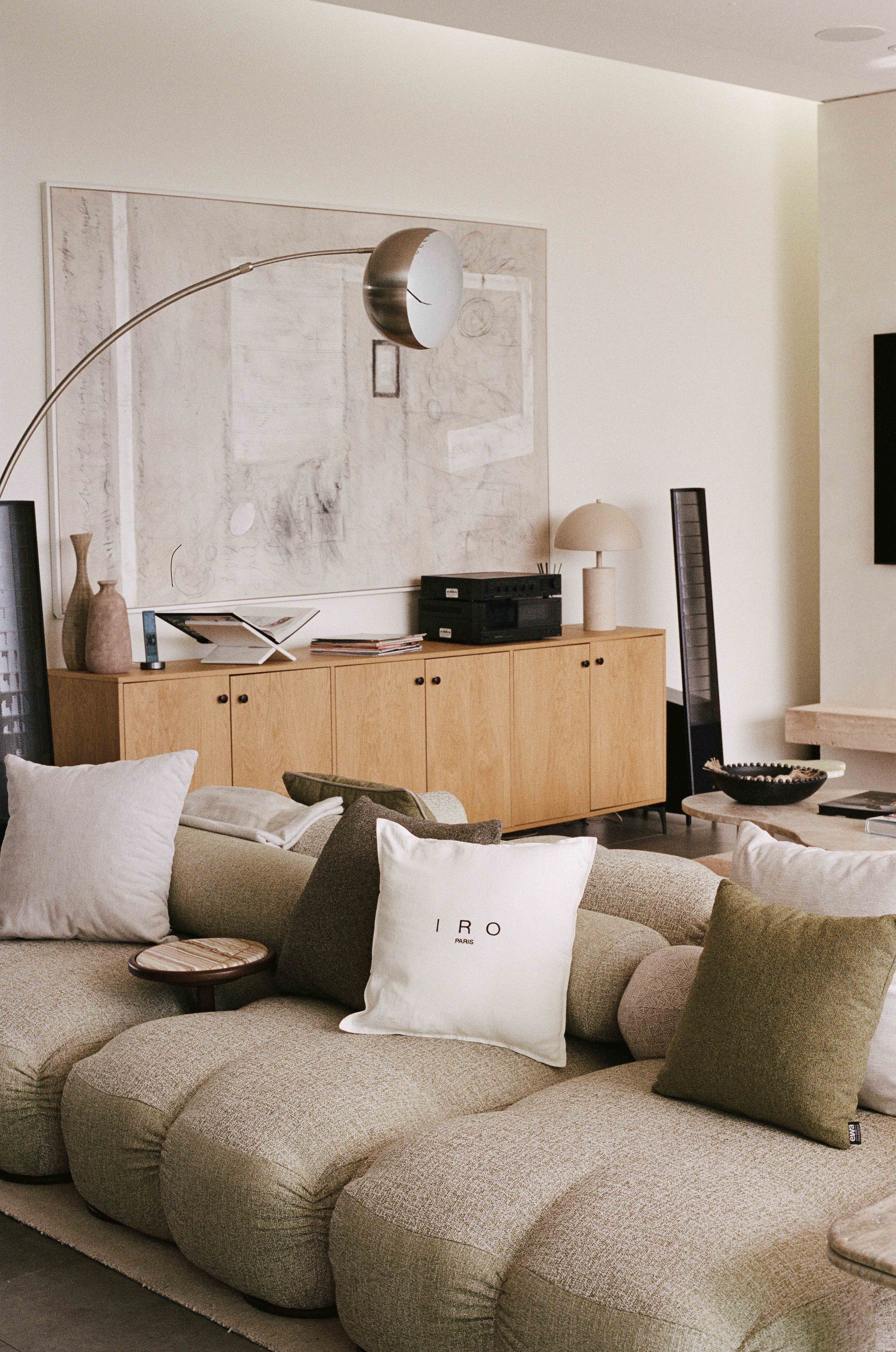 Warm living room with a white IRO Paris pillow on a beige sofa