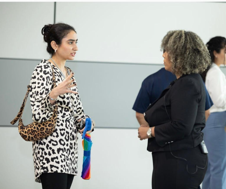Vanya speaking with a collaborator