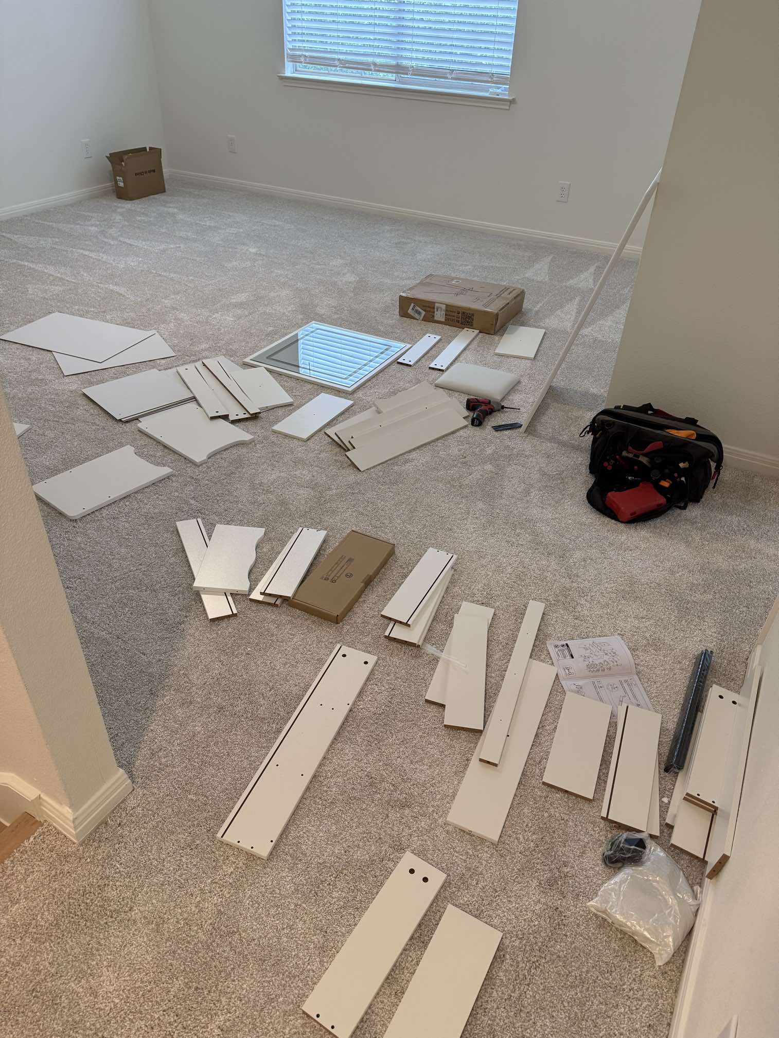 Furniture assembly in progress with vanity parts