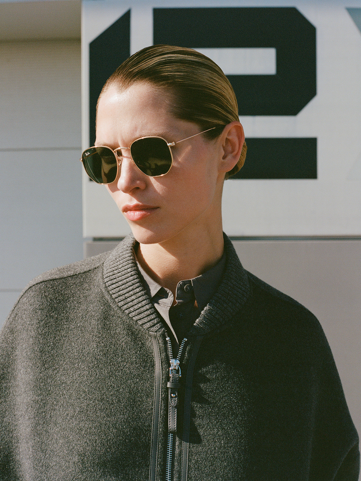 Campaign — grey bomber jacket, outdoor sunlight