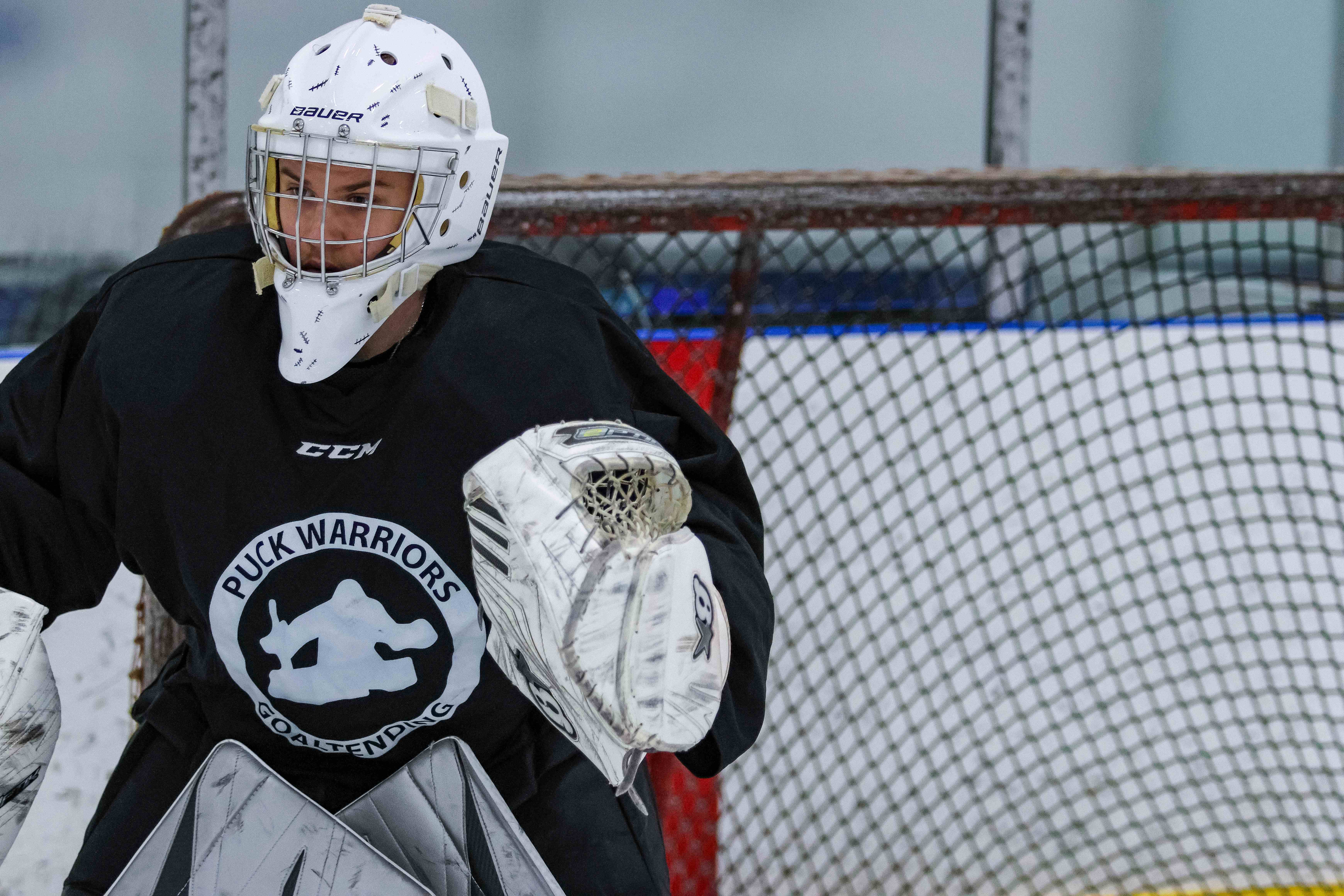 Goalie making a glove save during Puck Warriors training