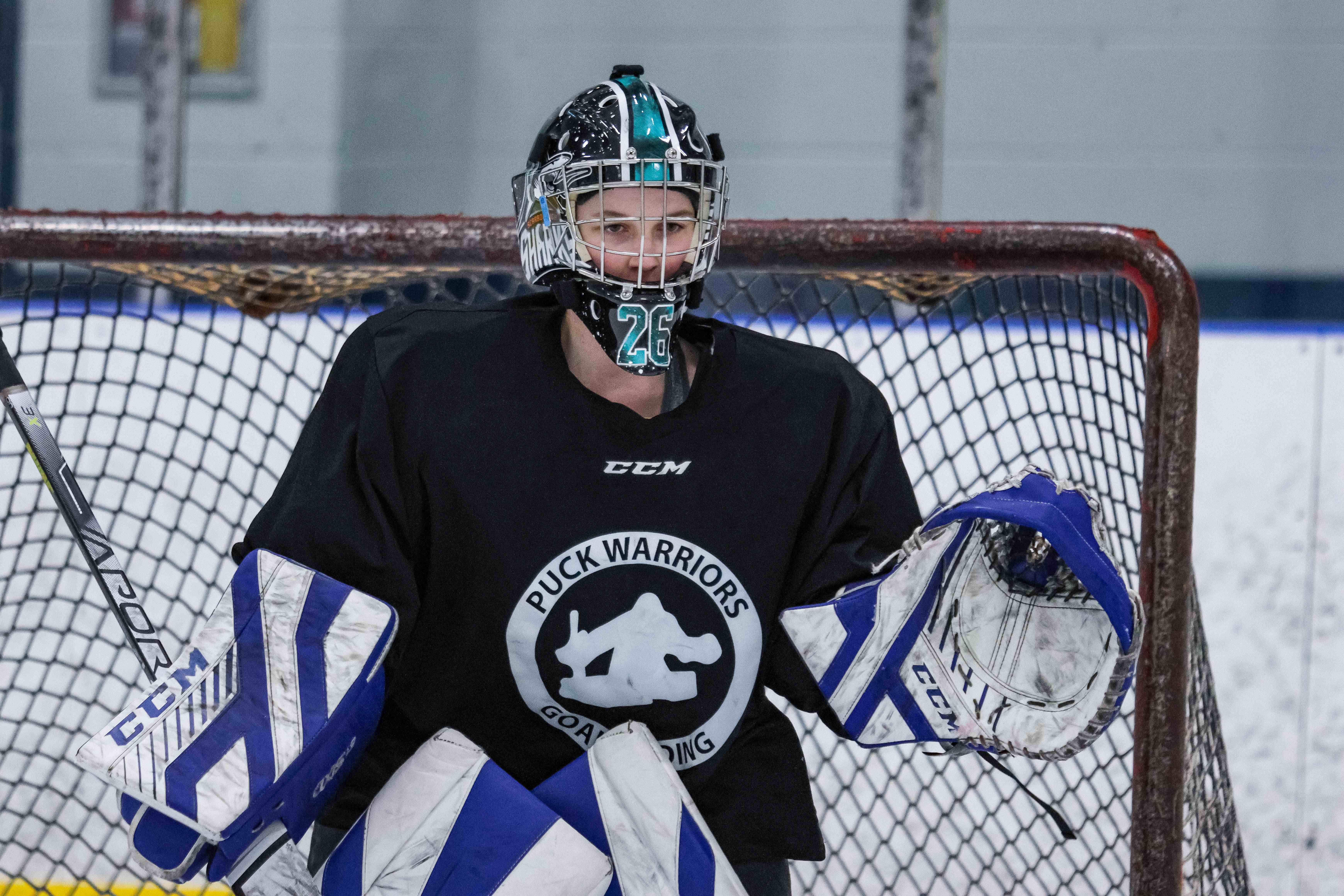 Goalie in a Puck Warriors jersey with full gear