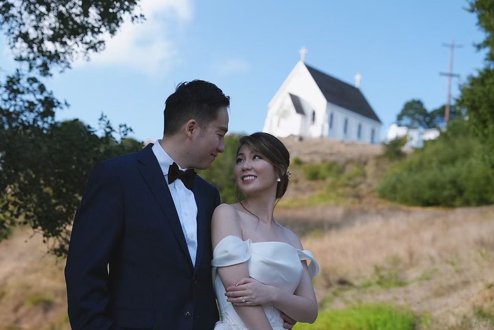 Couple portrait with white church in background