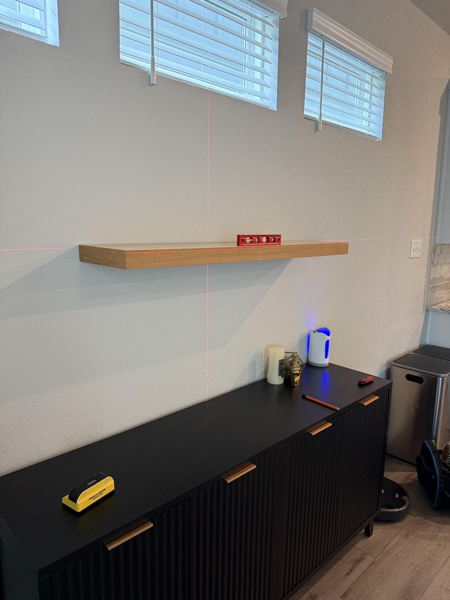Floating shelf mounted above console