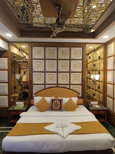 Family Room with a centered double bed and decorative wood-and-gold detailing