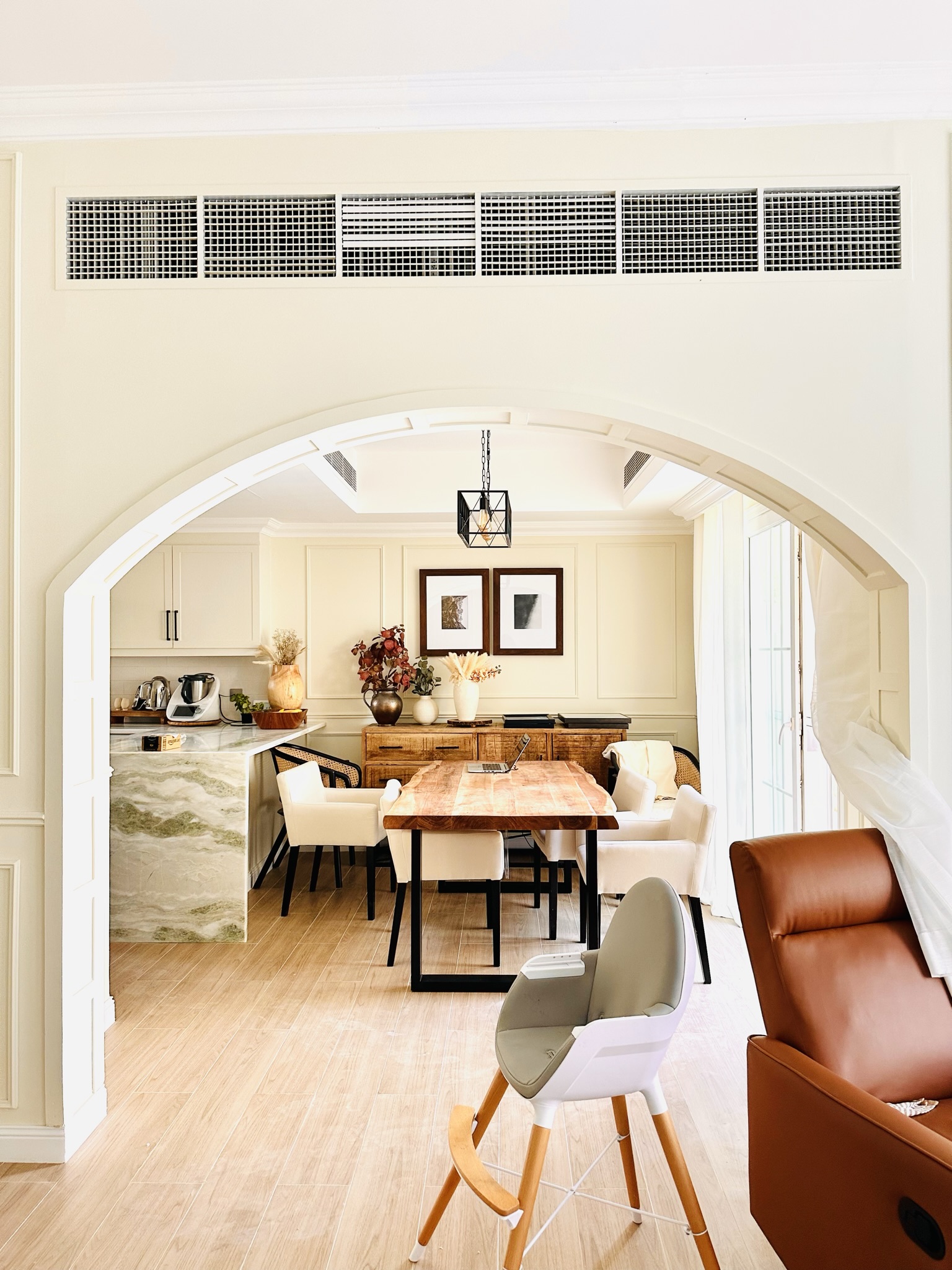 Dining area with arched entrance and rustic table