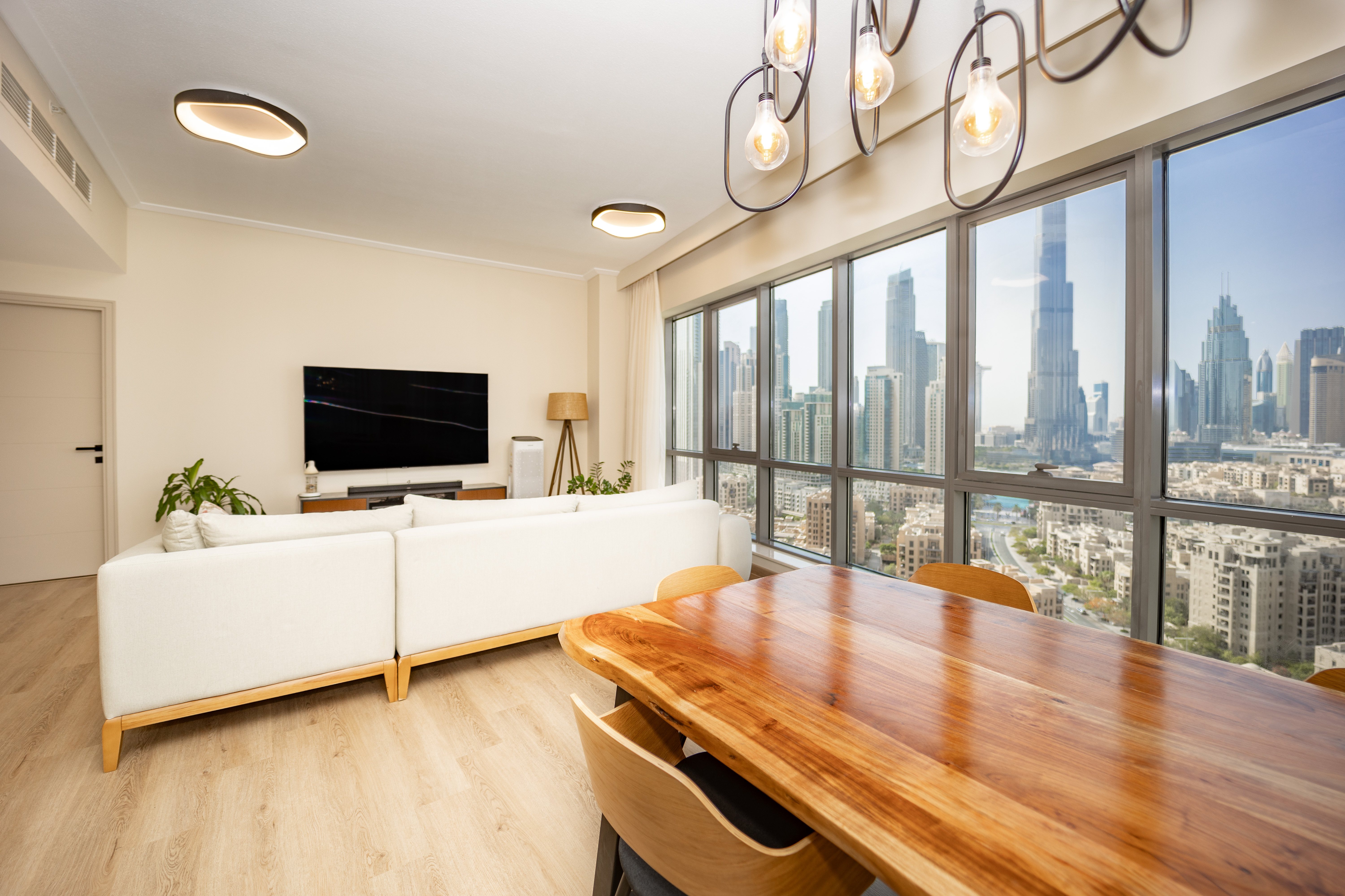 Modern living dining room with wood table and city skyline views