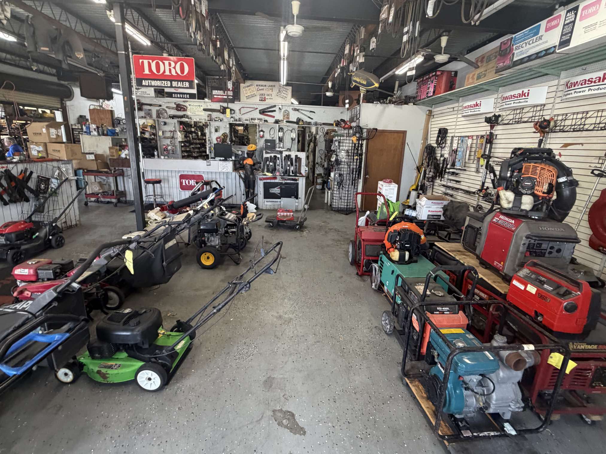 Shop floor with various generators including Honda and portable models