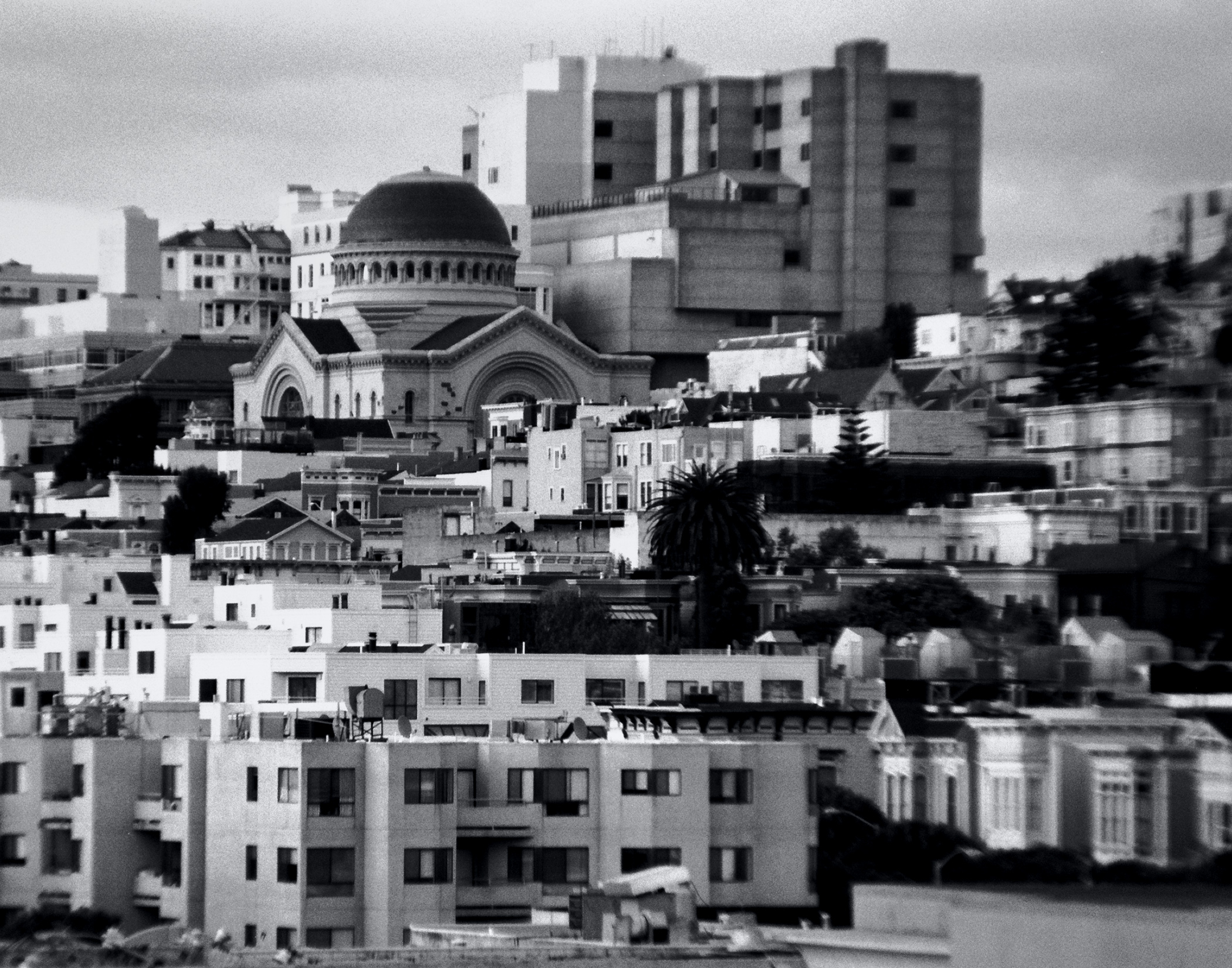 San Francisco cityscape featuring white Orthodox Saints Peter and Paul Church with dome surrounded by residential buildings and modern architecture
