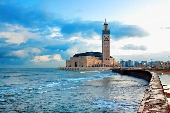 Hassan II Mosque from the ocean sea wall with stormy sky