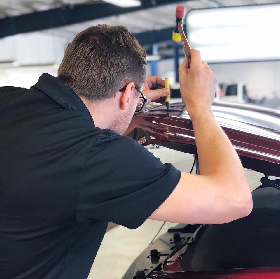 Dent Force PDR technician working on a vehicle roof panel