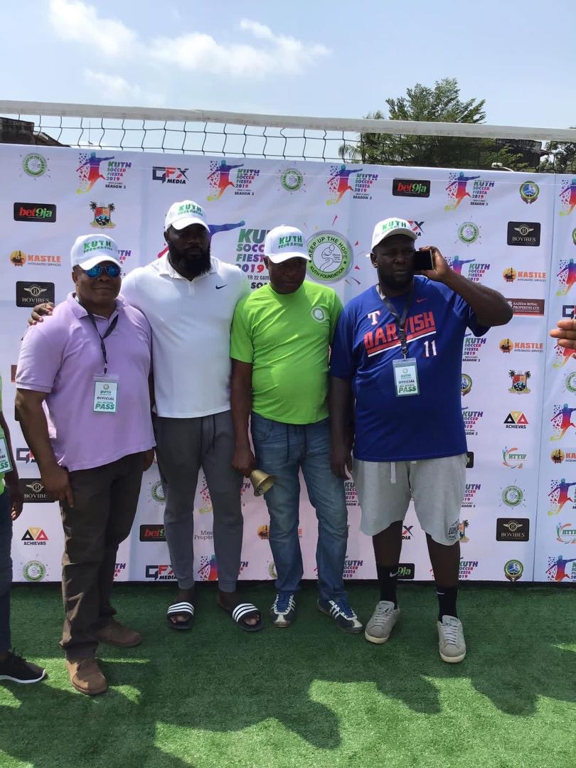 Founder with officials at the Soccer Fiesta backdrop