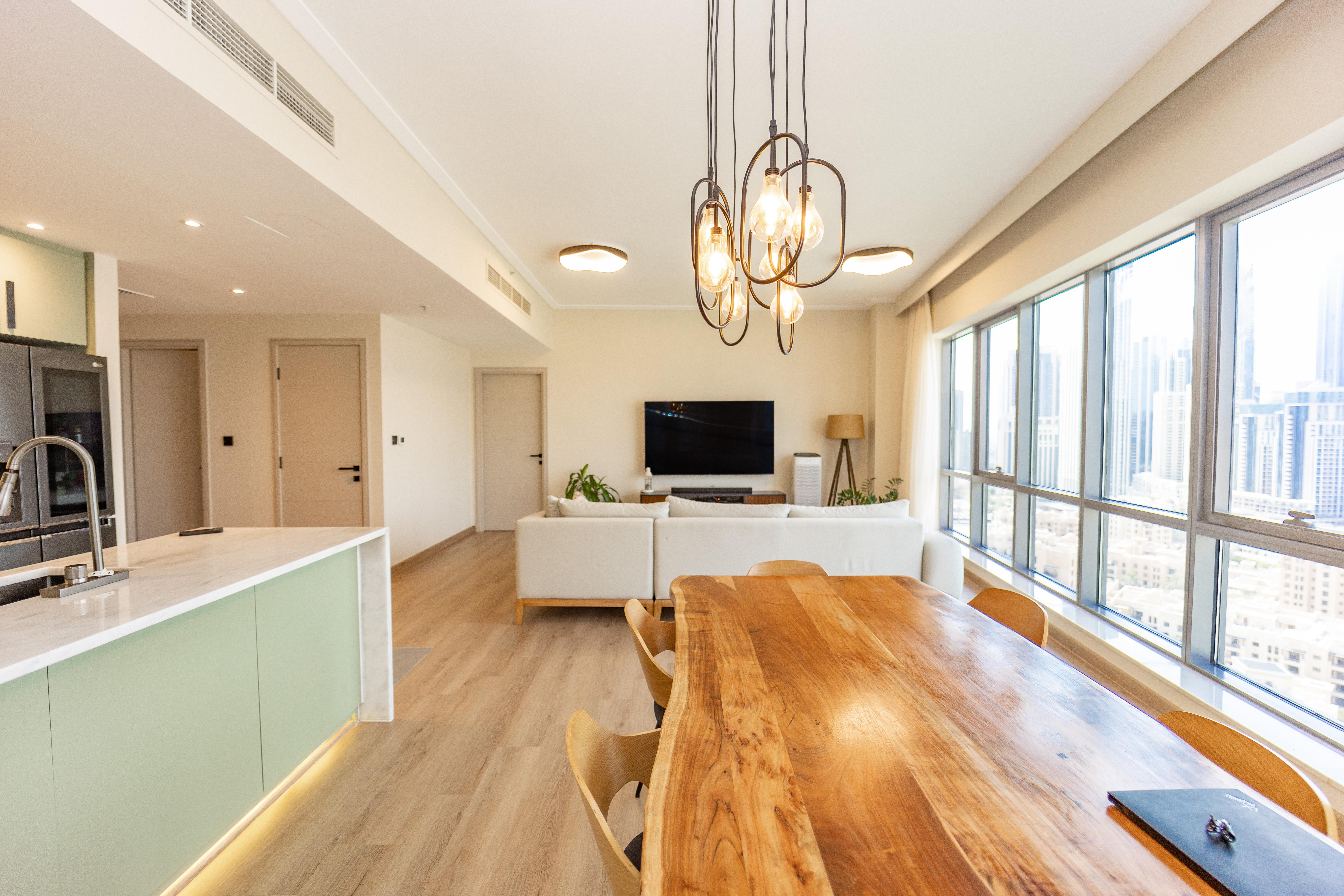 Open-plan living with mint green kitchen island and city views