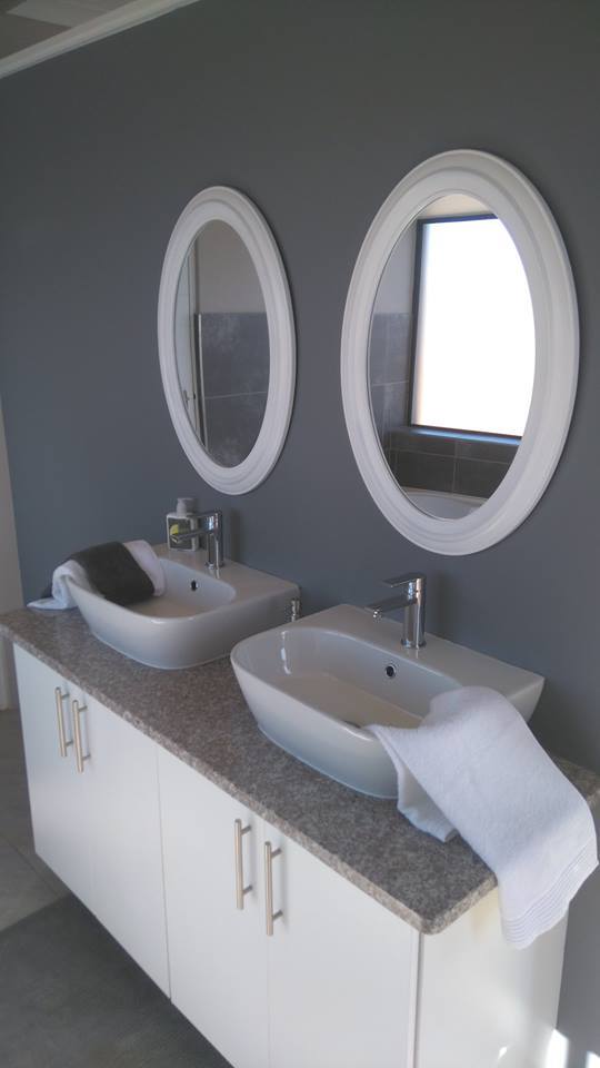 White Double Vanity with Oval Mirrors