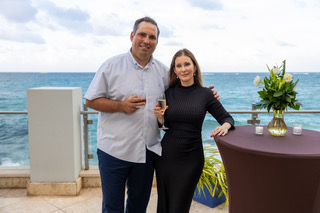 Couple networking by the ocean