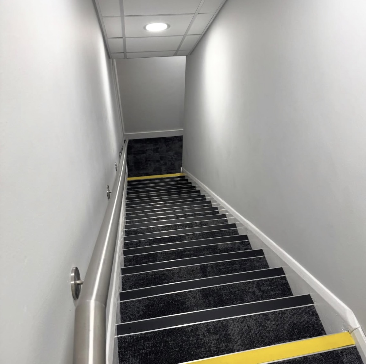 Commercial stairwell with carpet tiles and safety nosings