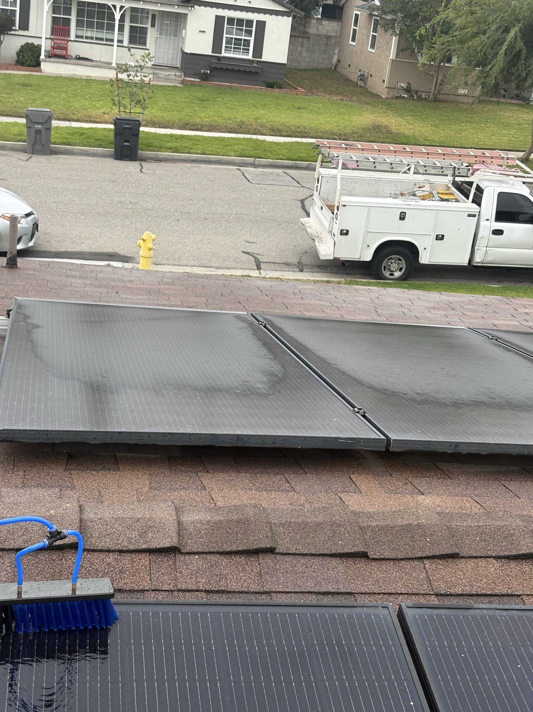Solar panel cleaning in progress with brush