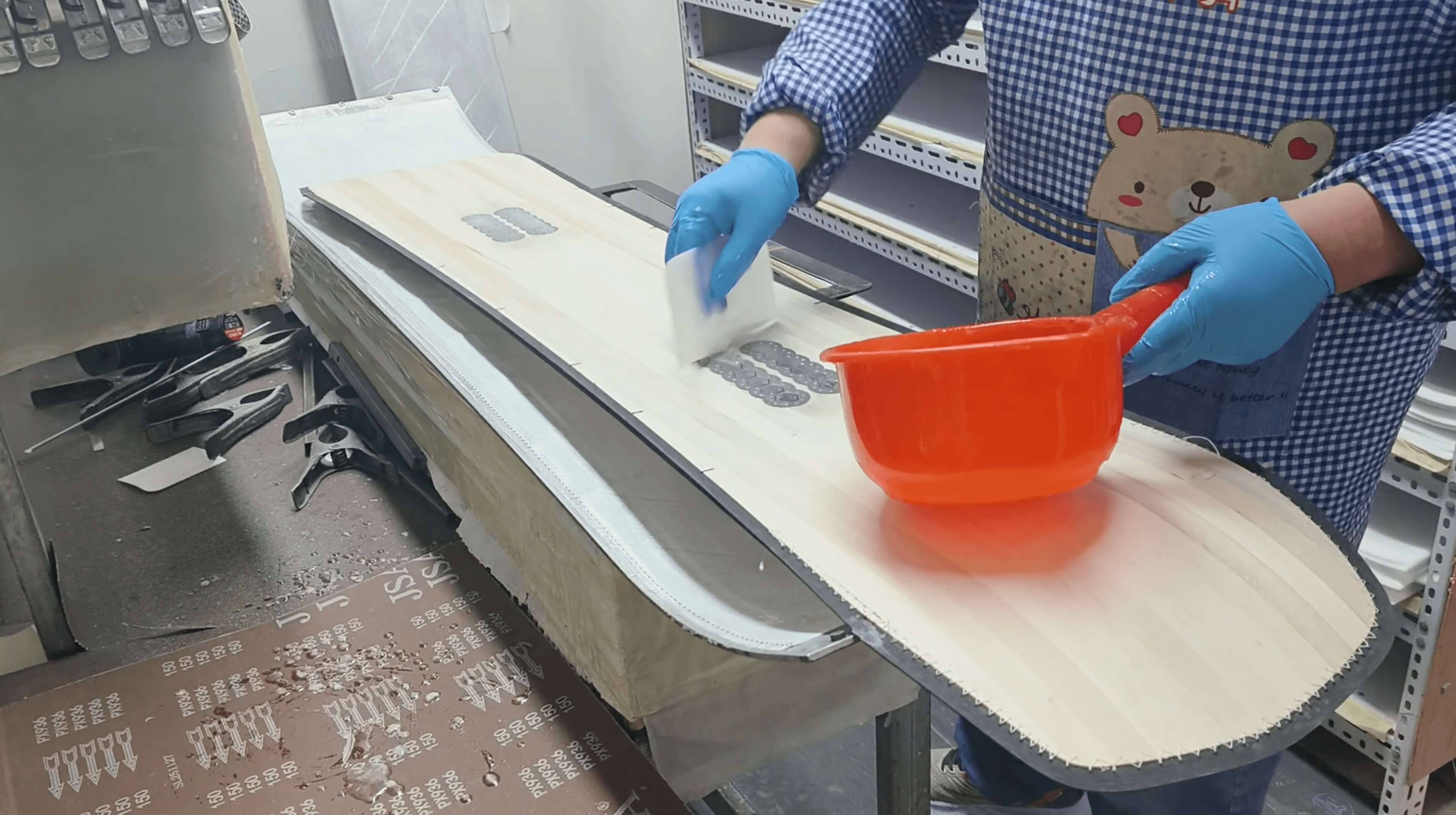 Poplar-paulownia wood core with pre-drilled binding insert holes being placed