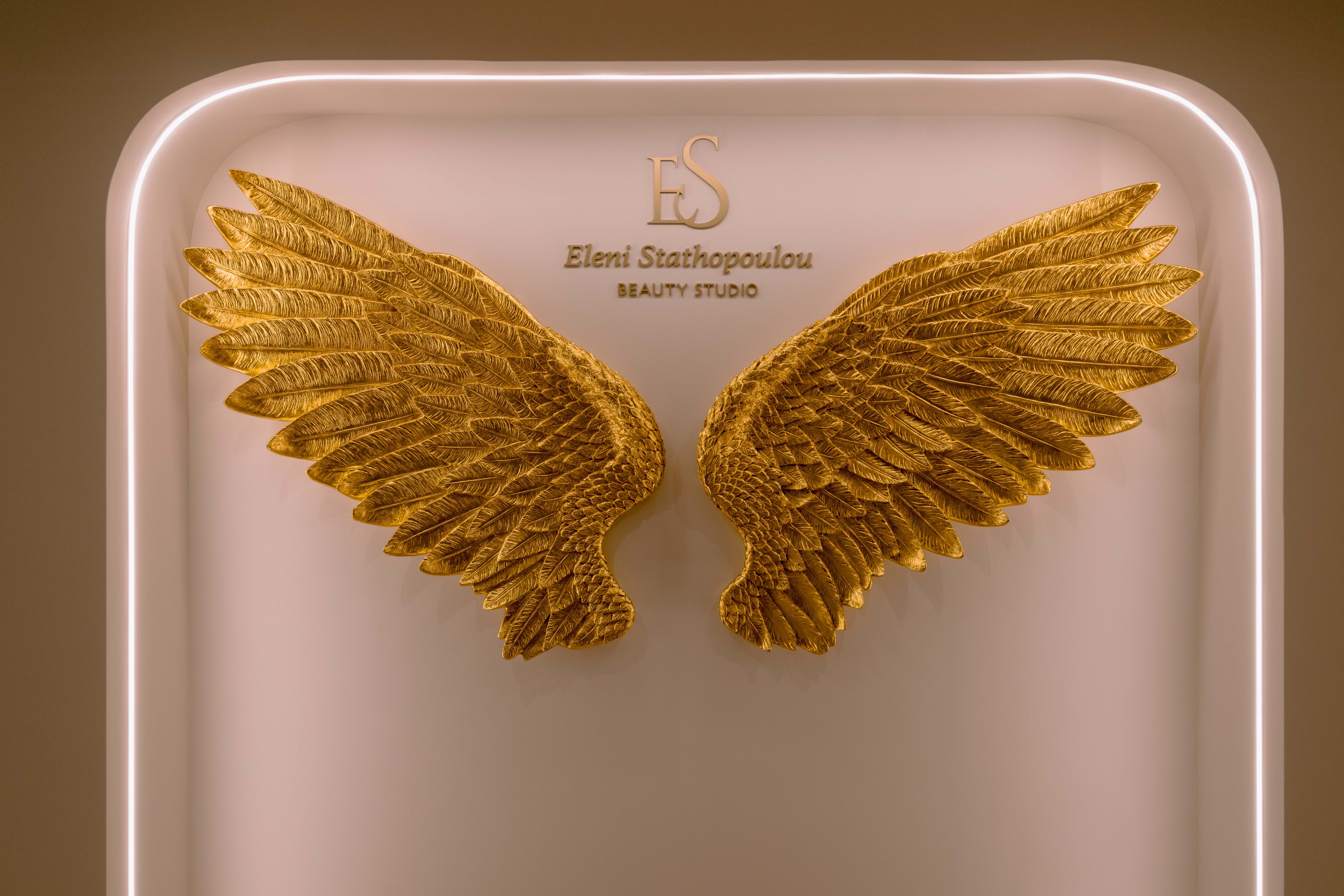Decorative golden angel wings wall art