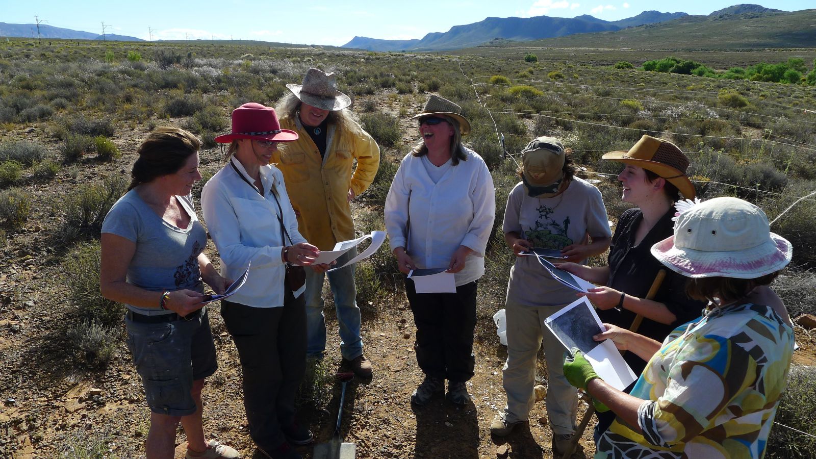 Team reviewing maps at geoglyph site