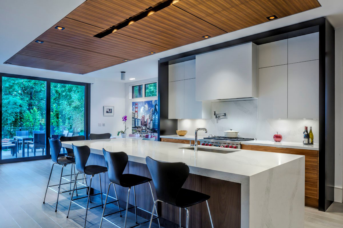 Contemporary kitchen with wood ceiling and white countertops
