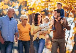 Multi-generational family walking together in autumn