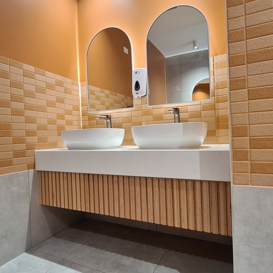 Floating timber bathroom vanity with LED underlighting and vessel basin
