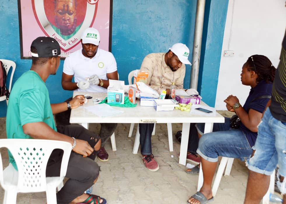 KUTH volunteers performing health screening with glucose meters
