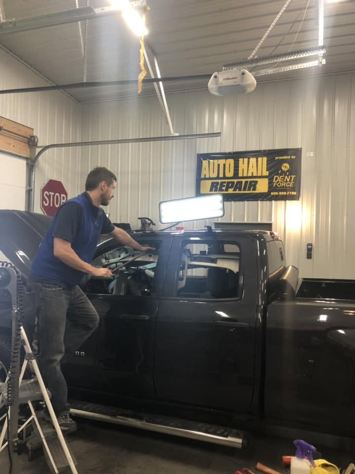 Dent Force technician repairing a truck at an Auto Hail Repair site