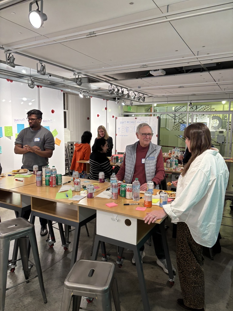 Diverse participants engaged in standing conversation