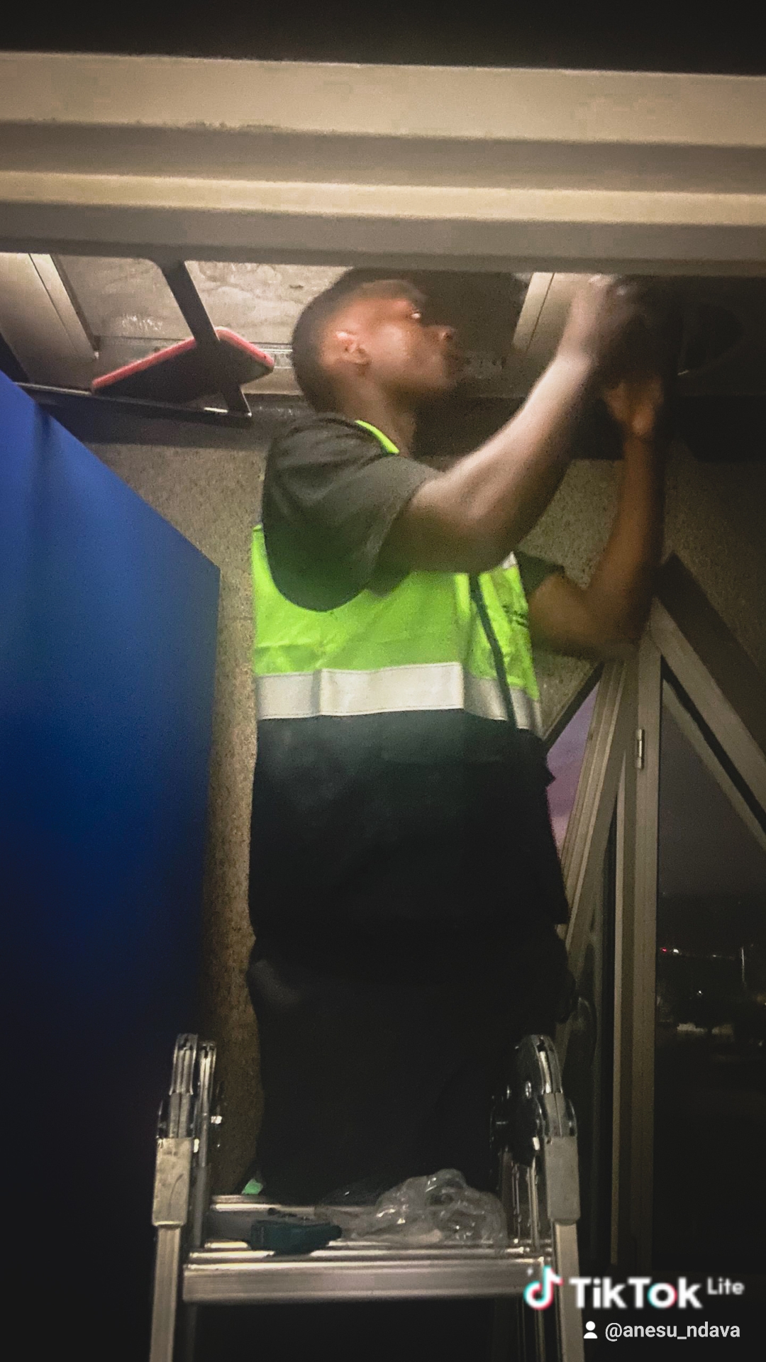 Engineer working above an aircraft cabin during an installation