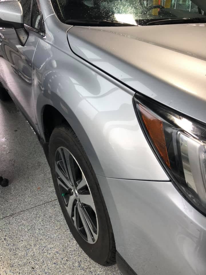 Silver SUV fender showing hail damage dents before PDR repair