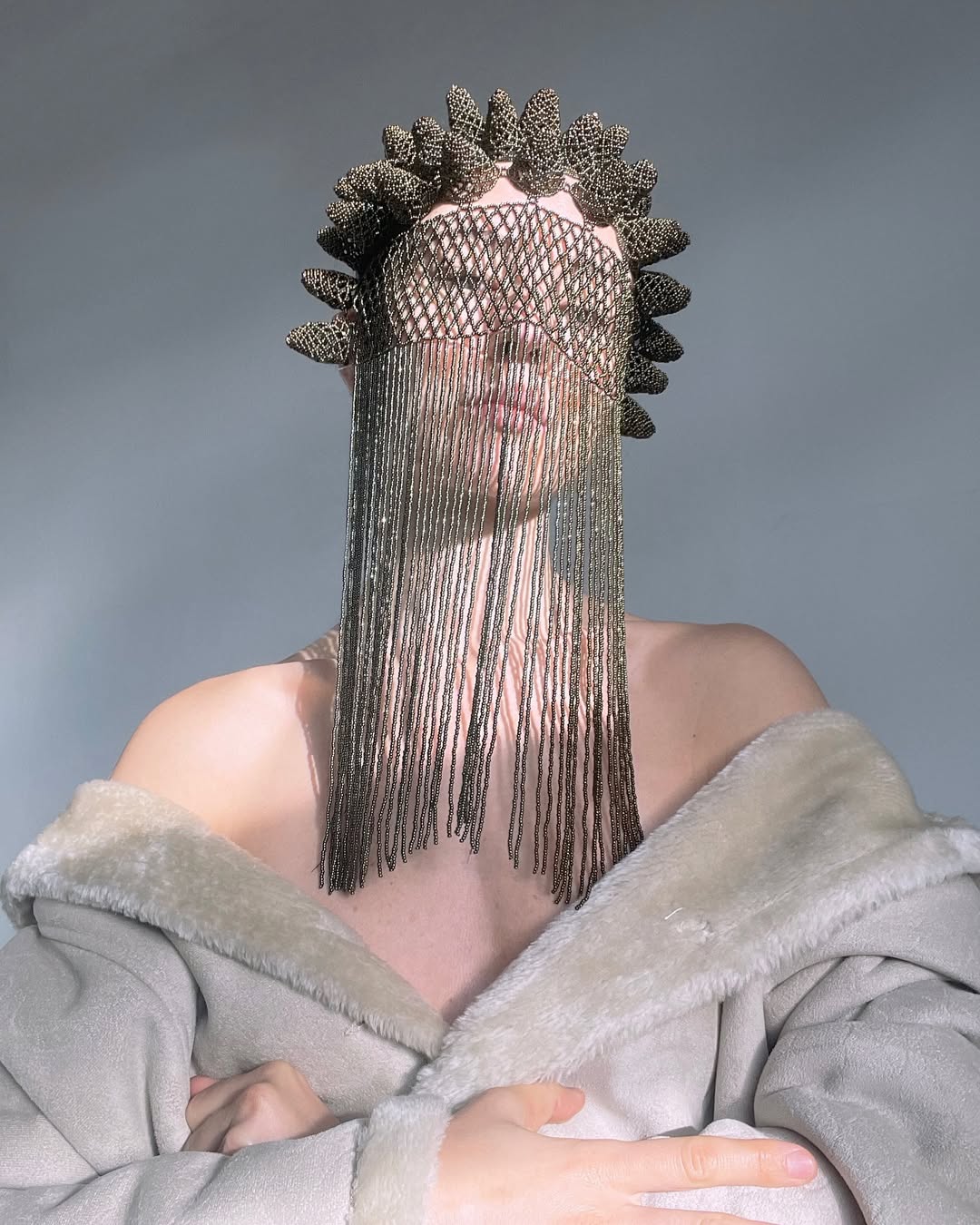Artistic portrait with metallic face covering