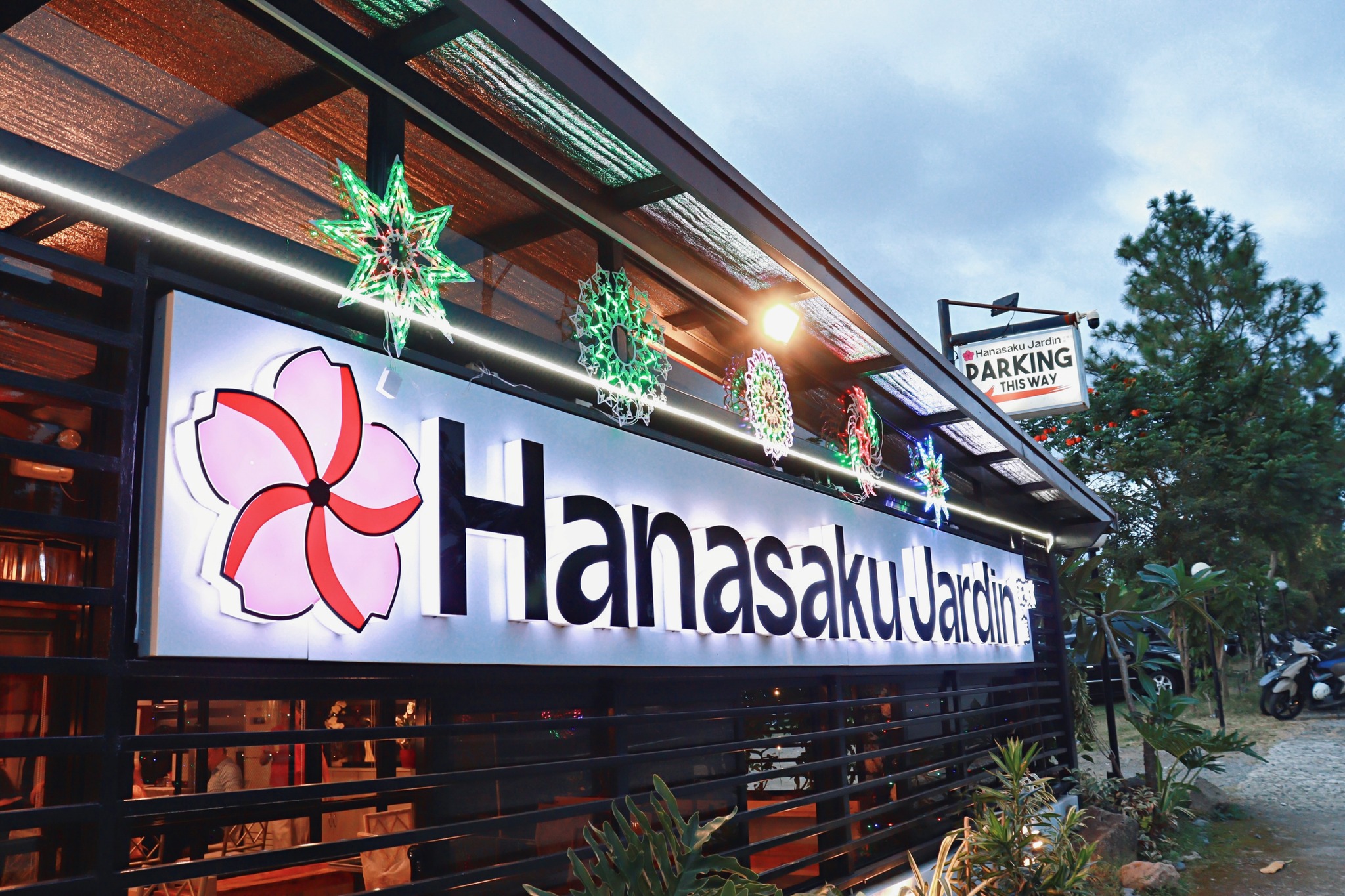 Hanasaku Jardin's elegant illuminated storefront with sakura logo