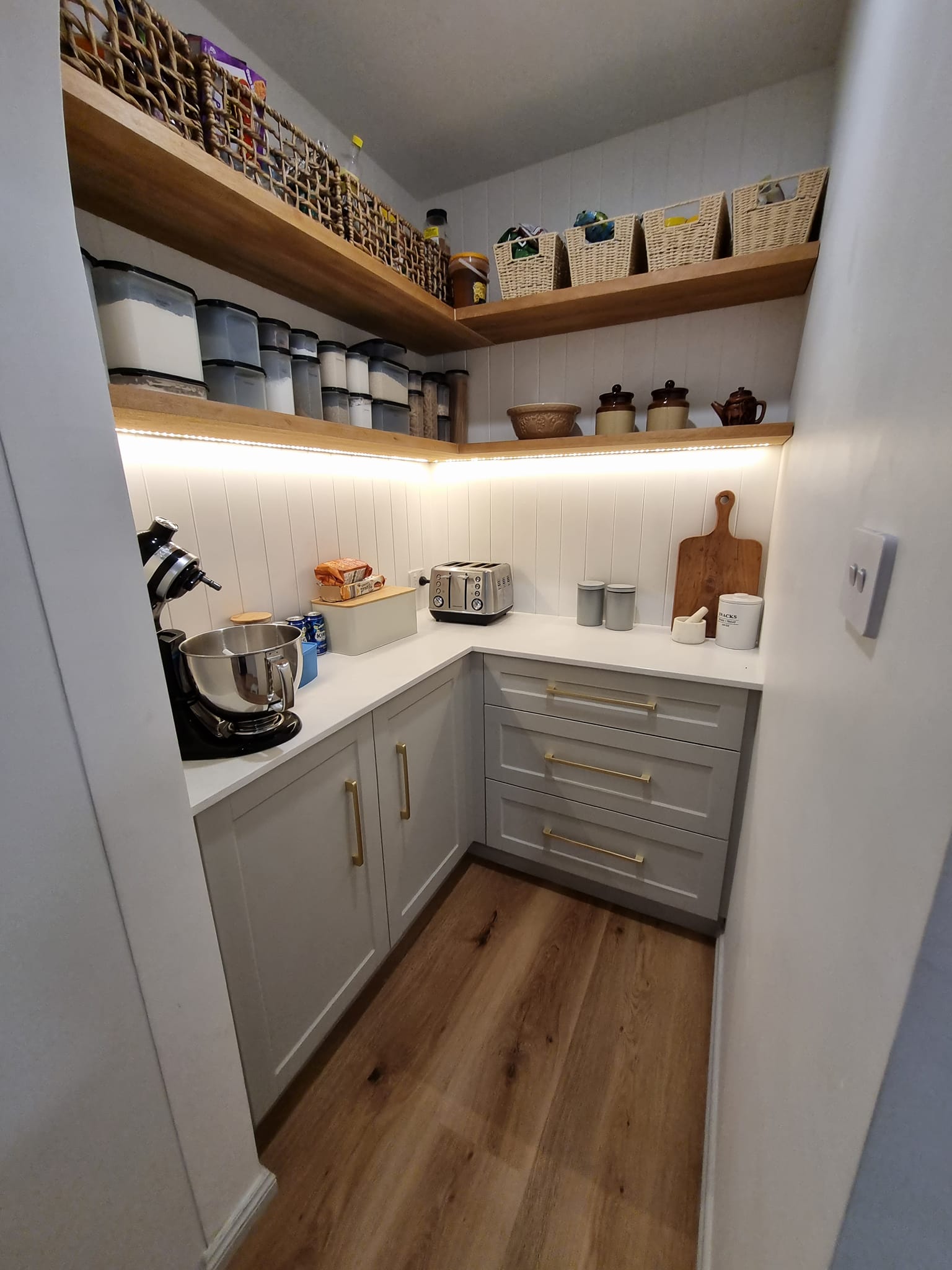 Butler's pantry with grey shaker cabinets and timber open shelving with LED lighting