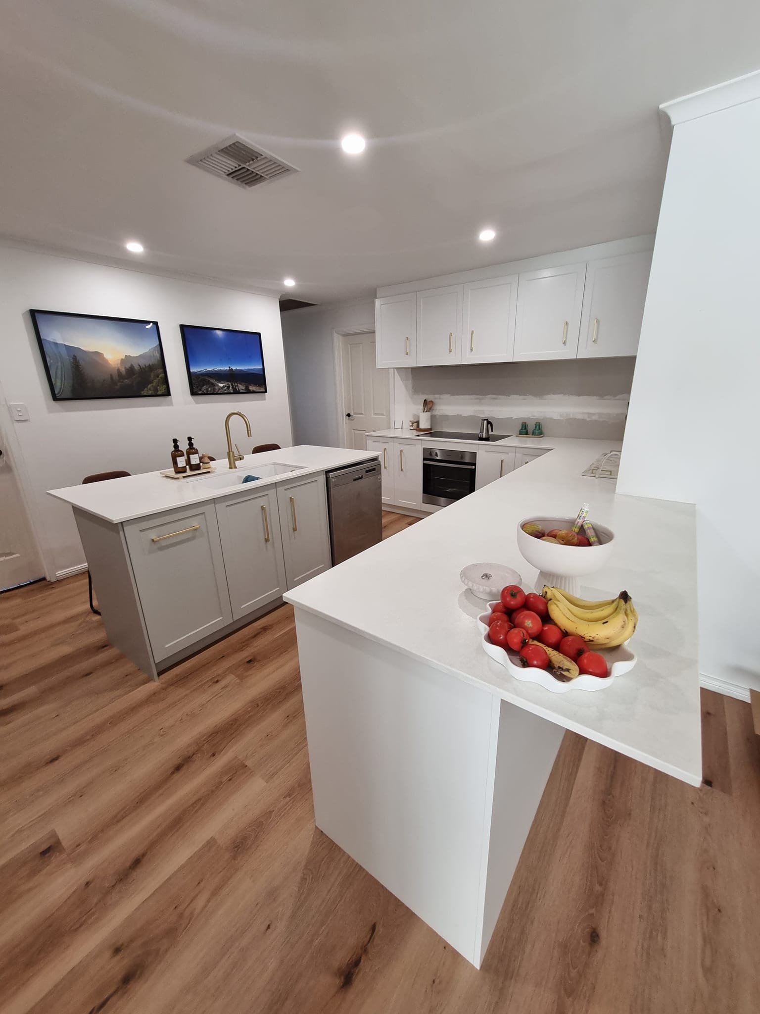 Modern white kitchen with island and gold hardware